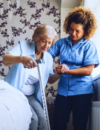 caregiver helping senior woman