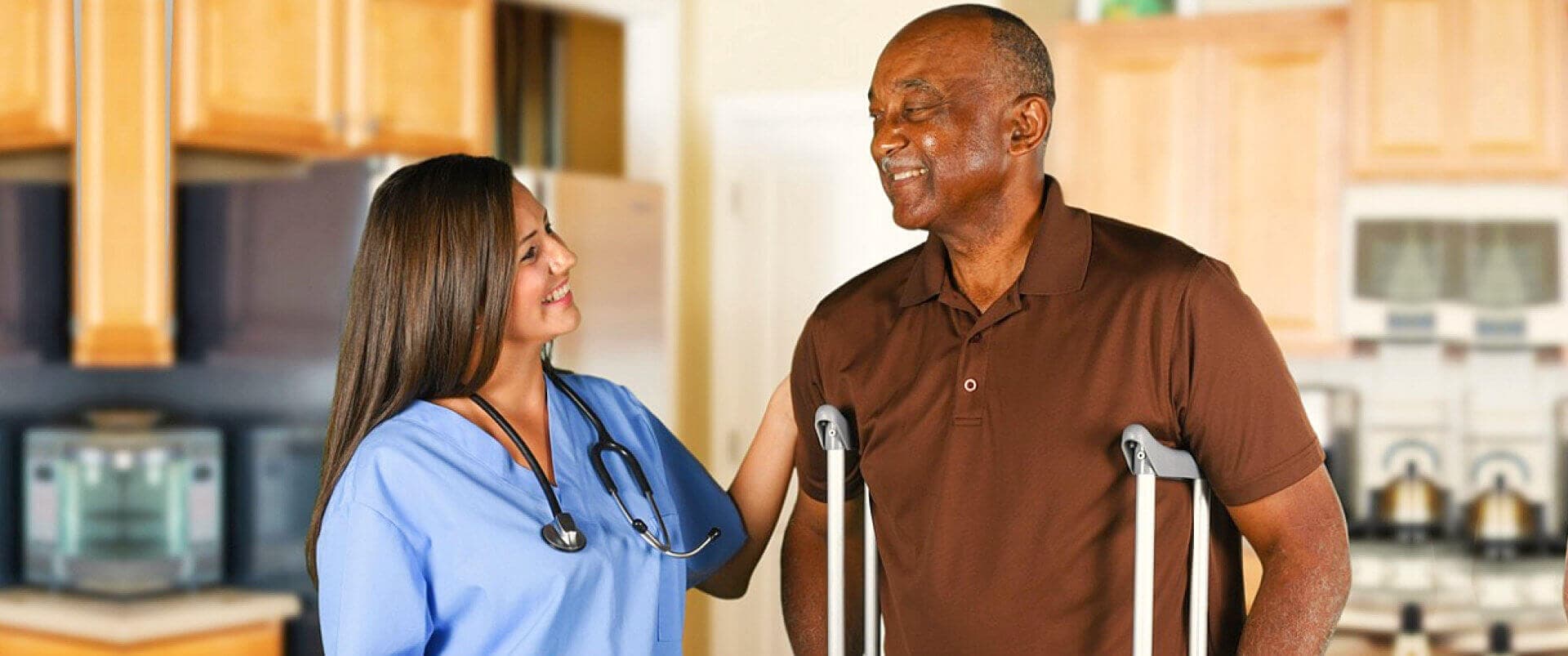 nurse and senior man smiling