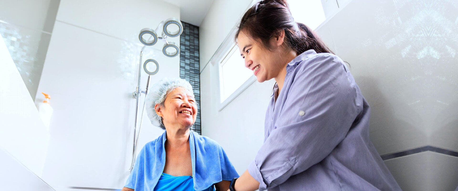 caregiver helping senior woman
