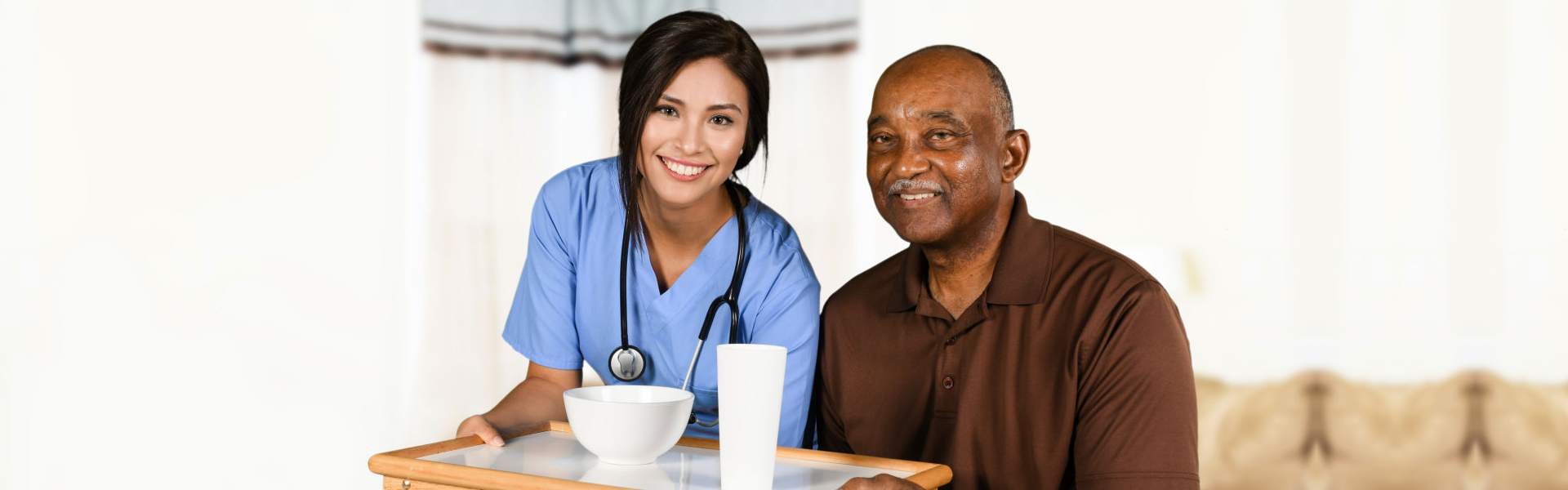 Health care worker helping an elderly patient