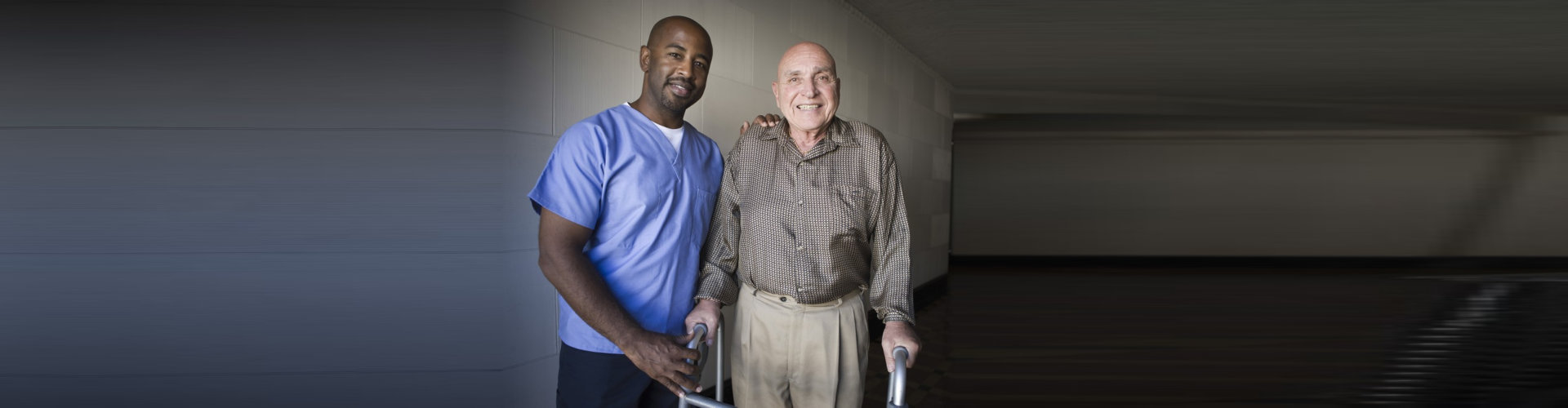 caregiver and senior man smiling